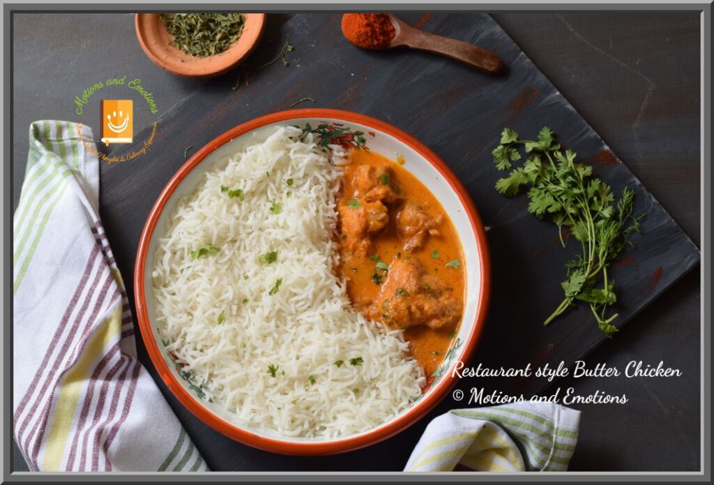 Butter chicken and rice in a white plate along with spices