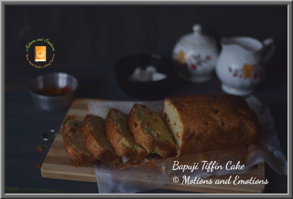 Bapuji Tiffin Cake Sliced on a wooden board side view