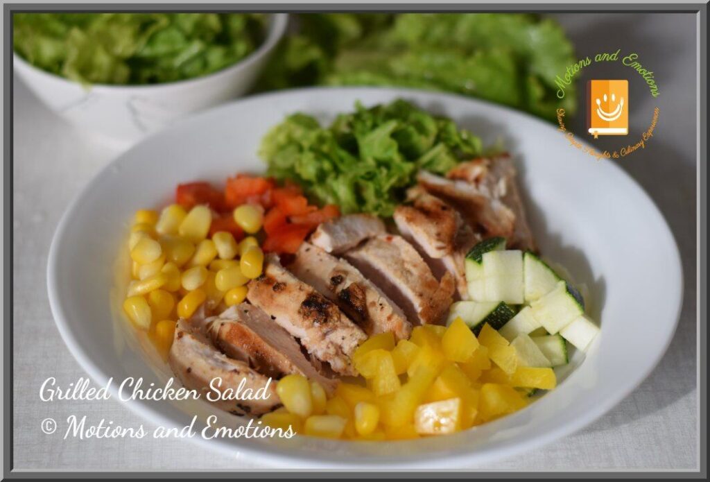 Grilled Chicken Salad in a white shallow bowl