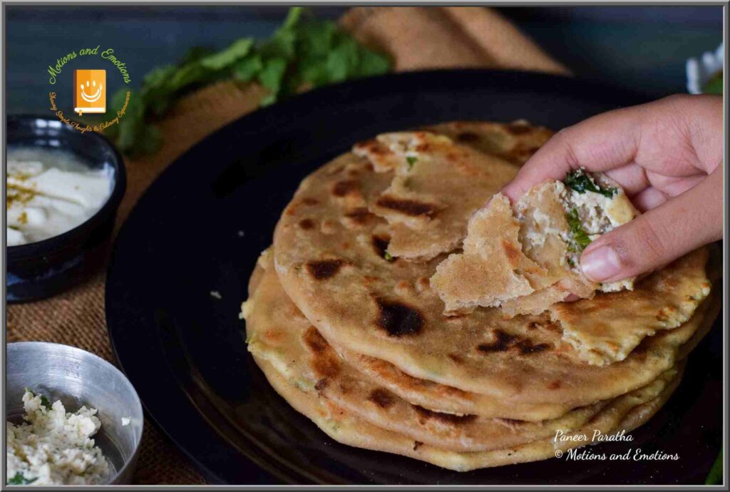 tearing paneer paratha with hand