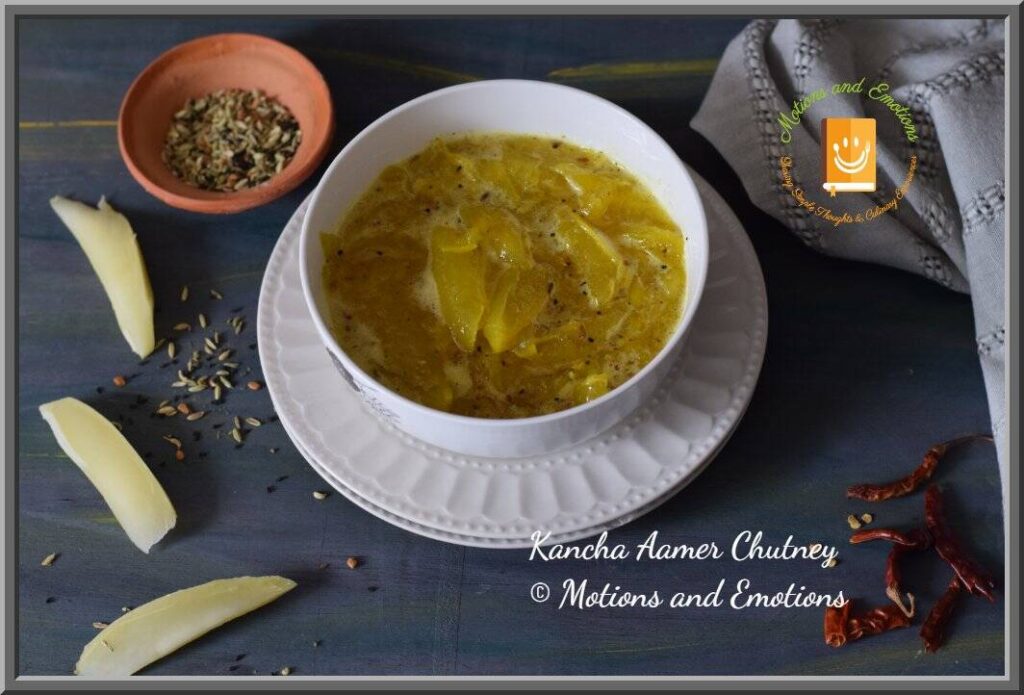 Kancha aamer chutney served in a white bowl along with spices