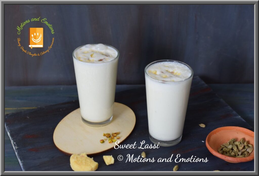 Sweet Amritsari Lassi in two glasses along with peda and cardamom