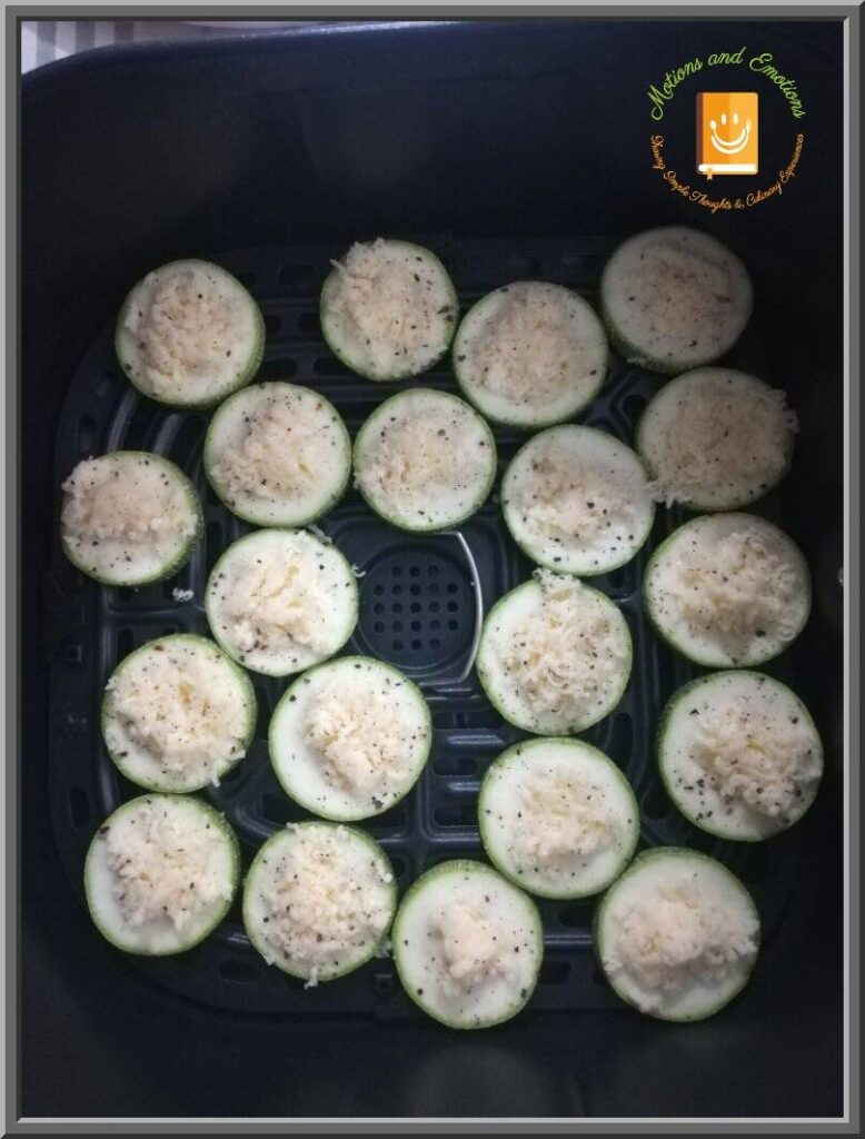 Zucchini rounds with cheese arranged in Air Fryer cooking tray