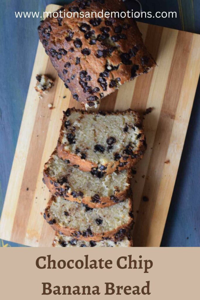 Chocolate chip studded banana loaf slices on a wooden board, pinterest template
