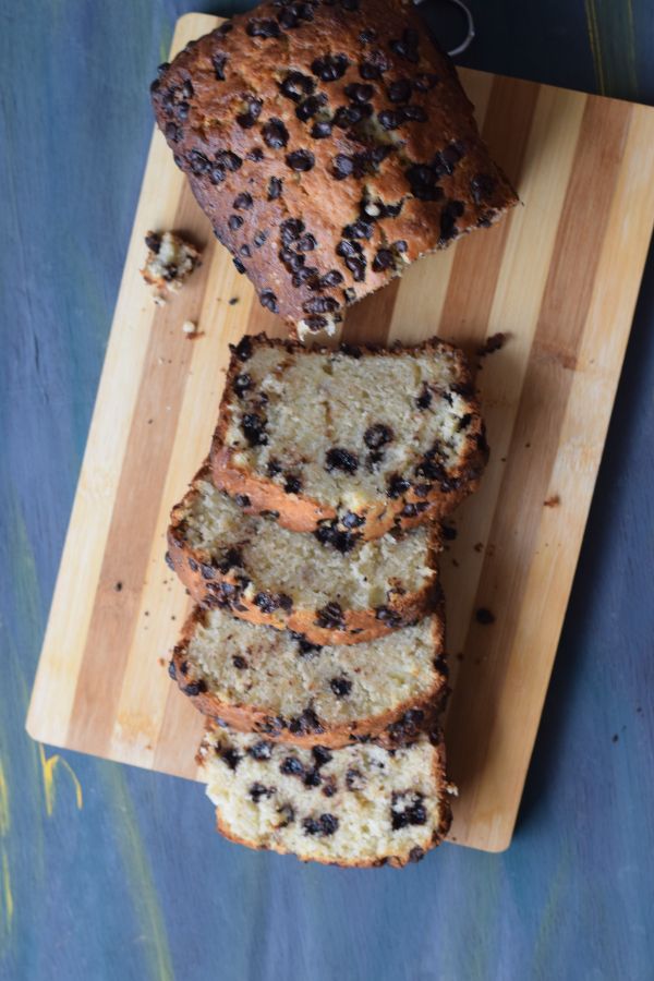 Banana loaf with choco chip sliced on a wooden board