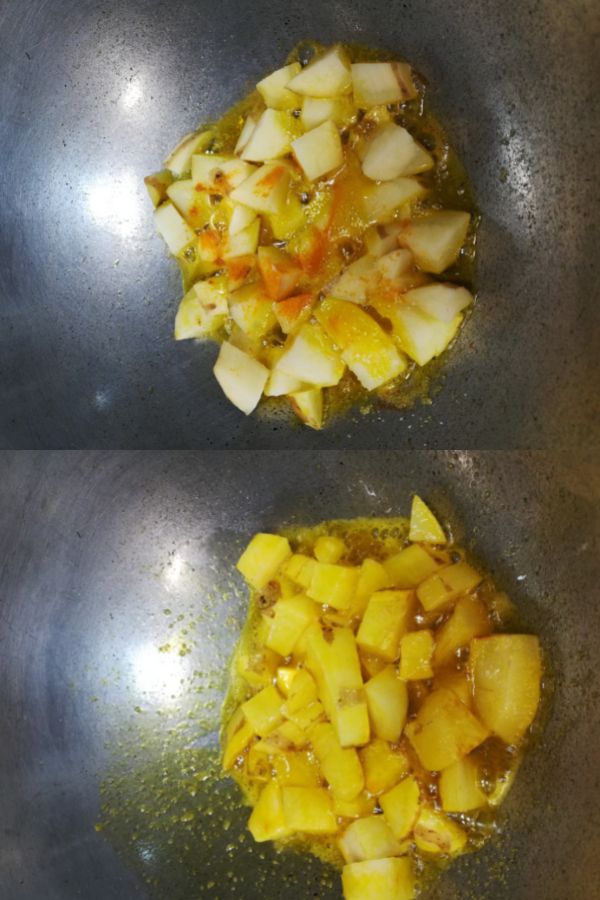 frying potato cubes with salt and turmeric powder