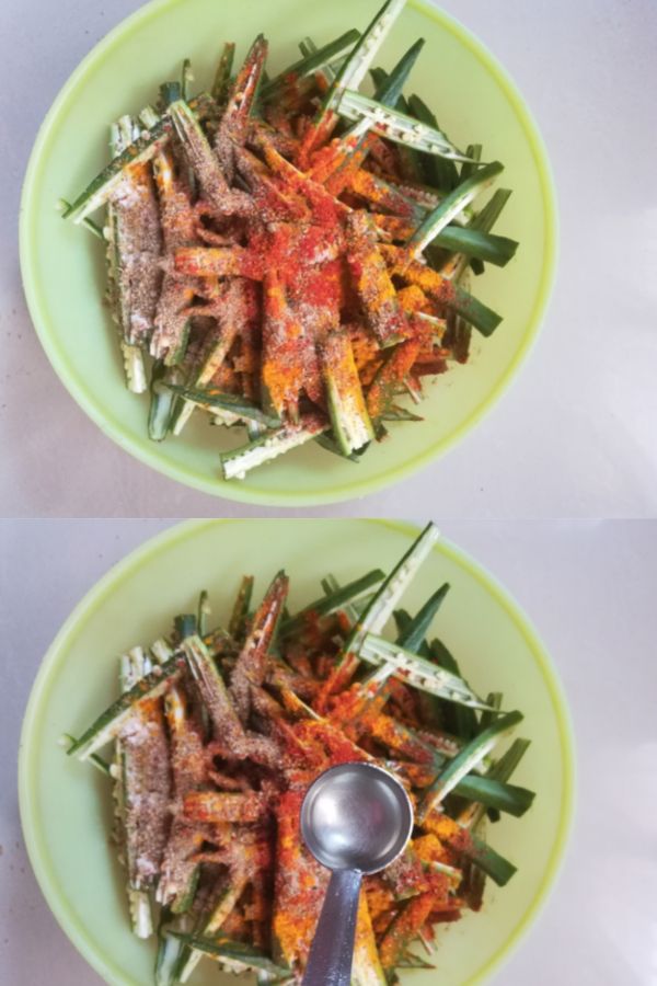 sliced okra coated with spice powders and oil has been added
