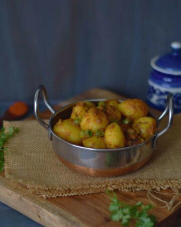 aloo dum in a small wok along with spices