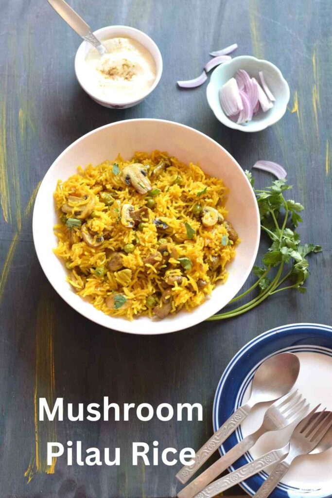 A bowl full of mushroom pilau rice along with curd, onion and cutlery in the background