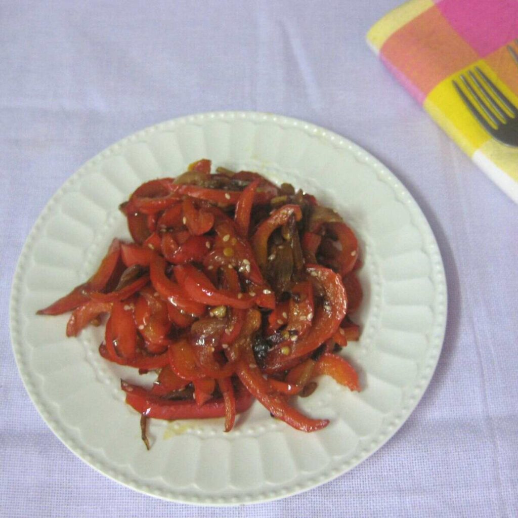 Stir fried red bell pepper in a white plate