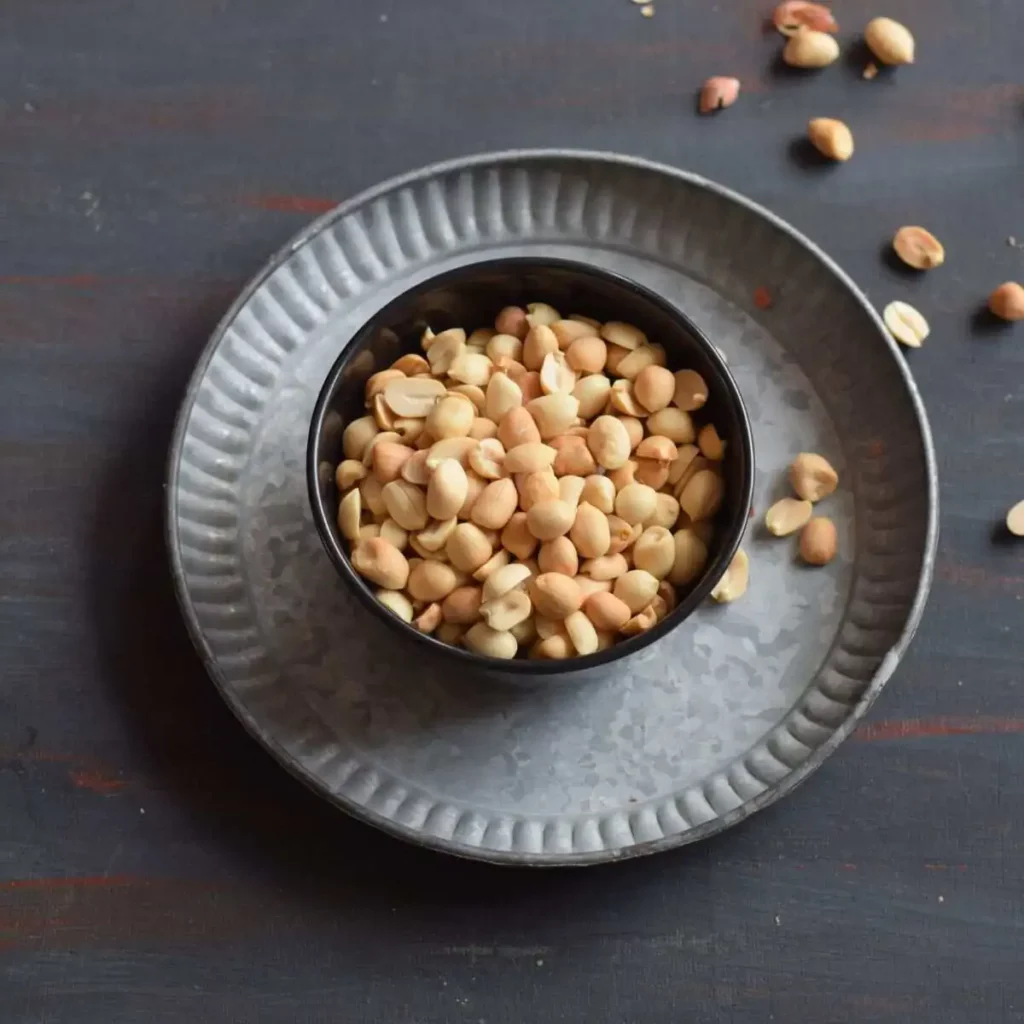 roasted peanuts without skin in a small bowl which is kept on plate