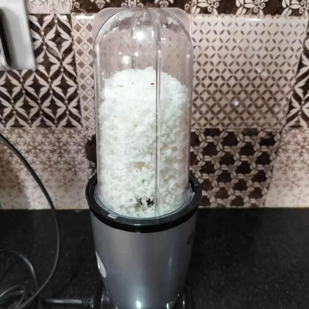 grinding coconut in a blender
