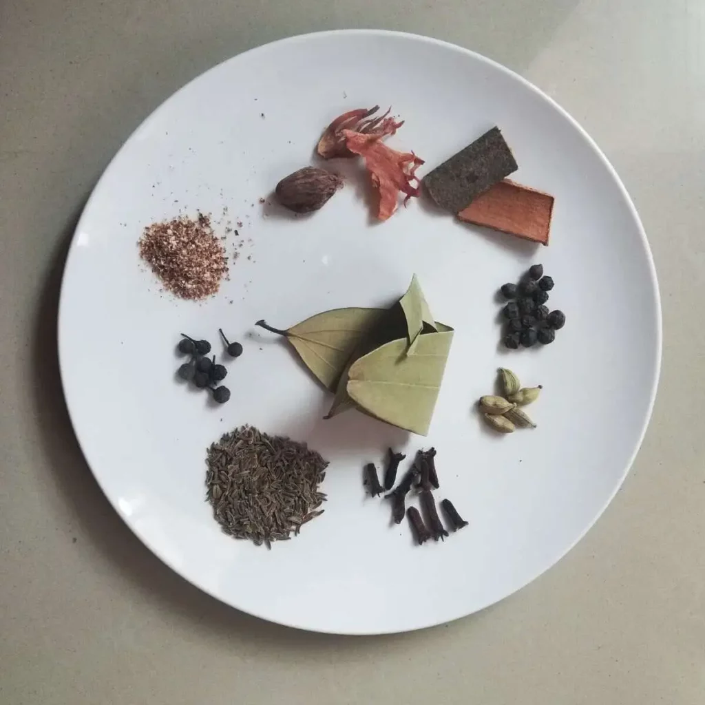 whole spices on a white plate