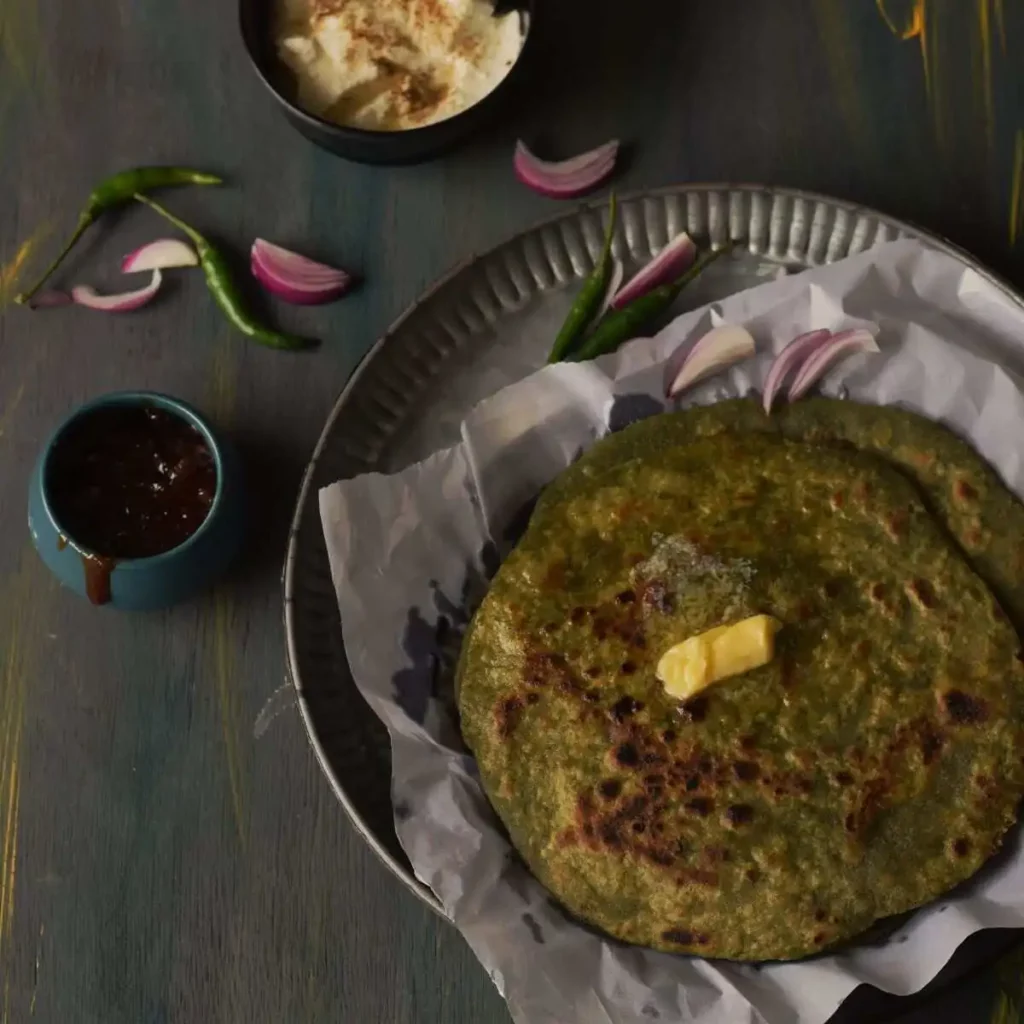 palak paneer paratha with butter on top