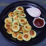 Air Fryer Zucchini Mozzarella served on a black plate along with ketchup and white dip