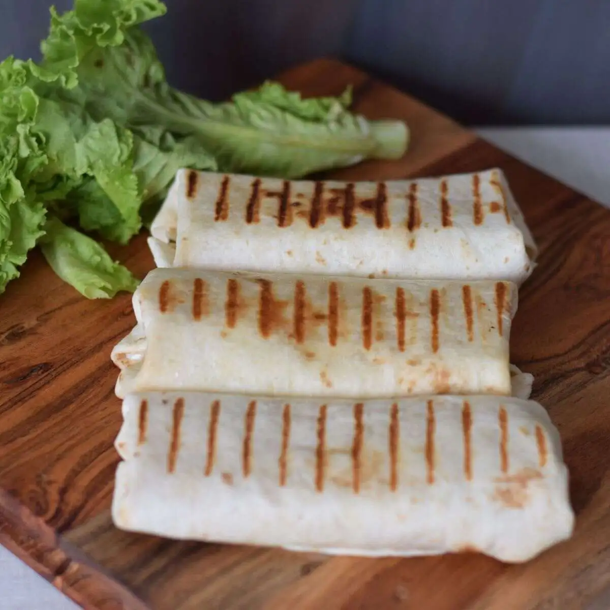 Grilled Chicken Wraps served on a wooden board