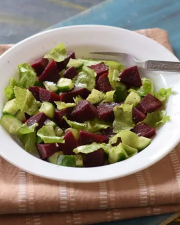 cucumber beetroot salad in a white bowl