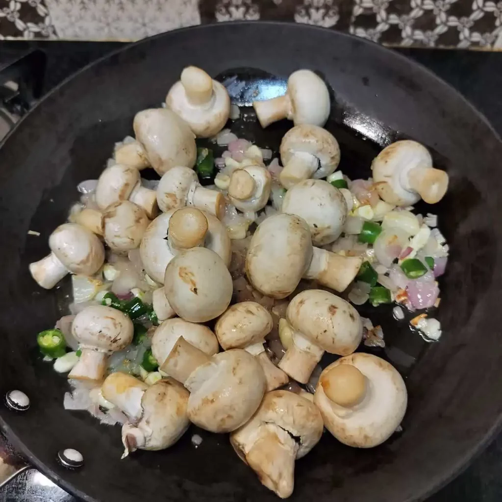 frying mushrooms with onion, garlic, chili