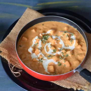 Paneer butter masala served in a pan