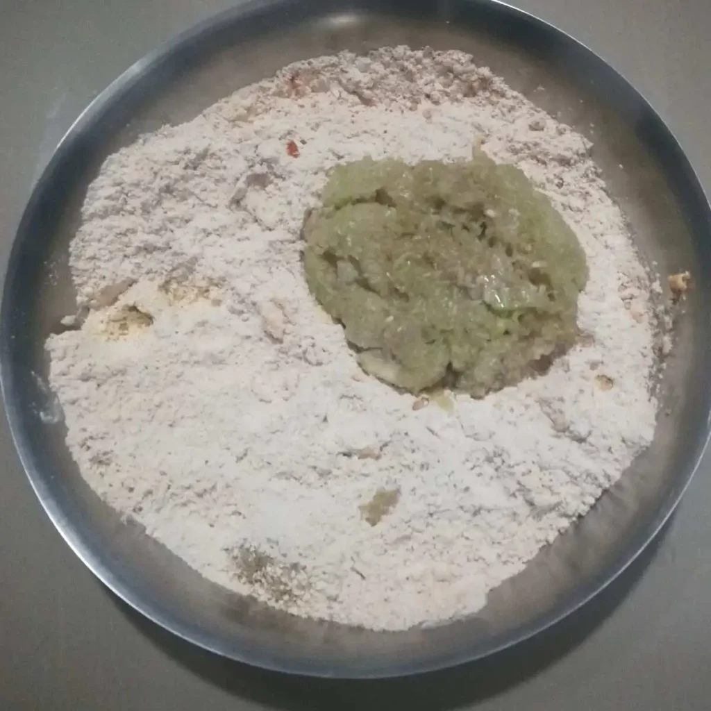 grated bottle gourd added to flour mixture